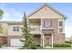Charming two-story home featuring brick accents, a balcony, and a well-manicured front lawn at 5619 Payne Blvd, Plainfield, IN 46168