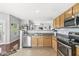 An inviting kitchen with stainless steel appliances, wood cabinetry, and a view into the adjoining living space at 5619 Payne Blvd, Plainfield, IN 46168