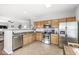 Well-lit kitchen showcases stainless steel appliances, wooden cabinets, and an open layout to the living area at 5619 Payne Blvd, Plainfield, IN 46168