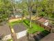 Aerial view of a lush, fenced backyard with well-maintained lawn and detached garages at 5622 Guilford Ave, Indianapolis, IN 46220