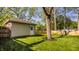 Detached garage in a landscaped yard with a mature tree and wooden fence at 5622 Guilford Ave, Indianapolis, IN 46220
