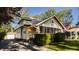 Charming exterior with a screened-in porch, mature landscaping, and a detached garage behind the house at 5622 Guilford Ave, Indianapolis, IN 46220