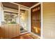 Cozy front porch with a wood door, 'welcome' mat, and screen door that opens to an interior living space at 5622 Guilford Ave, Indianapolis, IN 46220