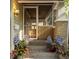 Charming front porch featuring brick supports and accents, room for seating and decor, and a storm door at 5622 Guilford Ave, Indianapolis, IN 46220