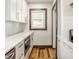 Bright kitchen featuring white cabinets, quartz countertops, stainless steel appliances, and modern fixtures at 5622 Guilford Ave, Indianapolis, IN 46220
