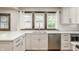 Bright kitchen featuring white cabinets, quartz countertops, stainless steel appliances, and a garden window over the sink at 5622 Guilford Ave, Indianapolis, IN 46220
