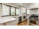 Bright kitchen featuring white cabinets, quartz countertops, stainless steel appliances, and modern fixtures at 5622 Guilford Ave, Indianapolis, IN 46220
