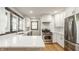 Bright kitchen featuring white cabinets, quartz countertops, stainless steel appliances, and modern fixtures at 5622 Guilford Ave, Indianapolis, IN 46220