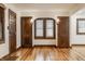 Cozy living room boasts hardwood floors, window with blinds and original trim at 5622 Guilford Ave, Indianapolis, IN 46220