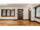 Spacious living room with hardwood floors, natural light, and traditional wood trim and moldings around windows at 5622 Guilford Ave, Indianapolis, IN 46220