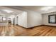 Open living space showing a kitchen and sitting area with hardwood floors and neutral wall colors at 5622 Guilford Ave, Indianapolis, IN 46220