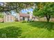 Backyard featuring a storage shed, a lawn, and beautiful landscaping at 6034 Doverton Dr, Noblesville, IN 46062