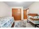 Bedroom featuring a built-in closet and classic interior door adjacent to a dollhouse at 6034 Doverton Dr, Noblesville, IN 46062