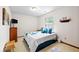 Well-lit bedroom with carpet, a full bed, and a view of nature outside the window at 6034 Doverton Dr, Noblesville, IN 46062