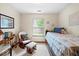 Bright bedroom featuring a cozy rocking chair, natural light, and a comfortable single bed at 6034 Doverton Dr, Noblesville, IN 46062