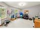 Well-equipped home gym with fitness equipment, ample natural light, and comfortable carpeting at 6034 Doverton Dr, Noblesville, IN 46062