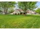 Beautifully landscaped yard surrounds this home with mature trees and lush green grass at 6034 Doverton Dr, Noblesville, IN 46062