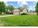 Attractive home with attached garage and a spacious, well-maintained lawn at 6034 Doverton Dr, Noblesville, IN 46062
