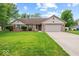 Charming ranch-style home with a well-manicured lawn, two-car garage, and inviting front entrance at 6034 Doverton Dr, Noblesville, IN 46062