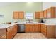 Well-lit kitchen featuring a window, wood cabinets, and white countertops at 6034 Doverton Dr, Noblesville, IN 46062