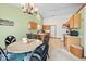 Eat-in kitchen featuring light-colored cabinets, matching appliances, a large window, and a dining table at 6034 Doverton Dr, Noblesville, IN 46062