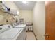 Functional laundry room featuring a modern washer and dryer, with overhead shelving at 6034 Doverton Dr, Noblesville, IN 46062
