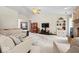 Bright living room featuring vaulted ceiling, ceiling fan, a cozy fireplace, and comfortable furniture at 6034 Doverton Dr, Noblesville, IN 46062