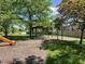 Community playground featuring a slide, swings, picnic tables, and a covered picnic area at 6034 Doverton Dr, Noblesville, IN 46062
