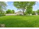 Expansive, fenced-in backyard featuring mature trees and a large grassy area at 6034 Doverton Dr, Noblesville, IN 46062