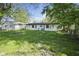 Wide-angle view of the backyard of the house with a grassy lawn at 611 Hampton Ln, Anderson, IN 46017