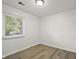 Cozy bedroom with wood-look flooring and a bright window, creating a comfortable and inviting space at 611 Hampton Ln, Anderson, IN 46017