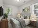 Nicely decorated bedroom with neutral paint, warm lighting, and TV on dresser at 611 Hampton Ln, Anderson, IN 46017