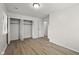 Bright bedroom with new flooring, closet with folding doors, and a door to another room at 611 Hampton Ln, Anderson, IN 46017