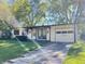 Charming single-story home with attached garage, inviting curb appeal, and lush landscaping at 611 Hampton Ln, Anderson, IN 46017
