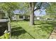 A view of the side yard with a partial view of the house at 611 Hampton Ln, Anderson, IN 46017