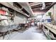 Unfinished basement features concrete floor, shelving, utility sink, exposed duct work, and natural light at 752 N Leland Ave, Indianapolis, IN 46219