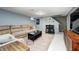 Basement living area features a large comfortable sofa, colorful rug, and entertainment area at 752 N Leland Ave, Indianapolis, IN 46219
