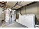 Basement utilities with modern washer and dryer, furnace and water heater, on concrete floor at 752 N Leland Ave, Indianapolis, IN 46219