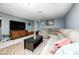 Basement living space with a large sectional sofa, a TV, and a colorful rug provides a comfortable retreat at 752 N Leland Ave, Indianapolis, IN 46219
