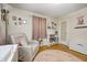 Charming bedroom with a chair, decorative elements, and natural light provides a cozy and inviting atmosphere at 752 N Leland Ave, Indianapolis, IN 46219