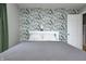 Serene bedroom featuring a full-size bed with floral wallpaper, soft lighting, and a white door at 752 N Leland Ave, Indianapolis, IN 46219