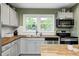 Bright kitchen with stainless steel appliances, butcher block counters, and a subway tile backsplash at 752 N Leland Ave, Indianapolis, IN 46219