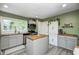 Updated kitchen with a center island, modern appliances, and stylish gray cabinetry at 752 N Leland Ave, Indianapolis, IN 46219