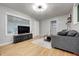 Bright living room with hardwood floors, a large window, and modern furnishings at 752 N Leland Ave, Indianapolis, IN 46219