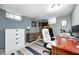 Functional basement office space features a desk, shelving, and a bright overhead light fixture at 752 N Leland Ave, Indianapolis, IN 46219
