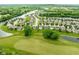 Aerial view of a neighborhood with lush greenery, a winding river, and well-maintained homes at 7559 Pipestone Dr, Indianapolis, IN 46217