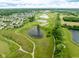 Aerial view of a golf course community with ponds, walking paths, and well-manicured fairways and greens at 7559 Pipestone Dr, Indianapolis, IN 46217