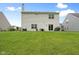 Spacious backyard with lush green grass and a patio, perfect for outdoor activities and relaxation at 7559 Pipestone Dr, Indianapolis, IN 46217