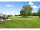 Spacious backyard with a pond view, perfect for outdoor activities and relaxation with a patio and seating area at 7559 Pipestone Dr, Indianapolis, IN 46217