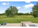 Expansive backyard view of lush lawn, mature trees, and scenic golf course, perfect for outdoor relaxation and entertainment at 7559 Pipestone Dr, Indianapolis, IN 46217